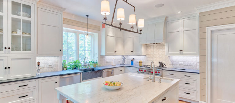 A white marble kitchen with custom lighting